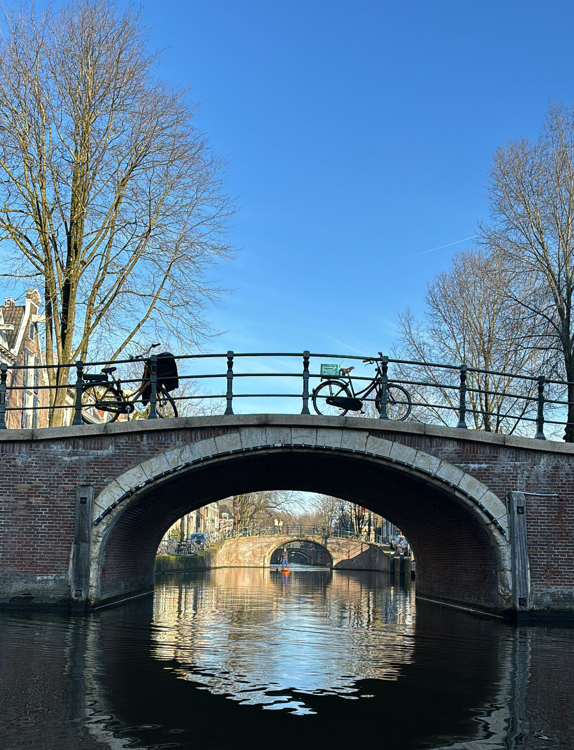 bikes on a canal bridge in amsterdam