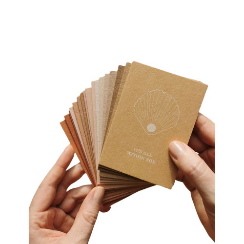 Set of 17 natural paper cards in a gold-embossed kraft box, designed for daily reflection and inspiration.