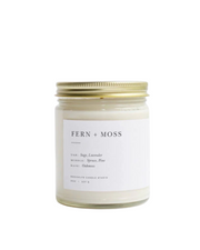 Fern + Moss candle in a clear glass jar with a minimalist label, featuring sage, lavender, spruce, and pine fragrance oils for a natural, outdoors-inspired scent. by Brooklyn Candle Studio