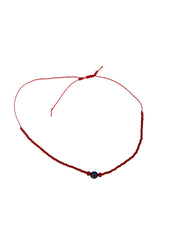 Red Seed Bead Evil Eye Bracelet with delicate red beads and protective evil eye charm, symbolizing love and protection, featuring an adjustable sliding knot closure.