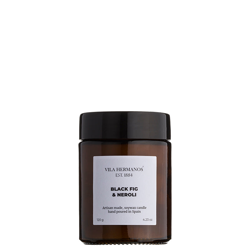 The Apothecary Black Fig & Neroli Candle in a minimalist glass jar, made with natural vegetable wax and a pure cotton wick, featuring a fresh fig, coconut, and floral fragrance.