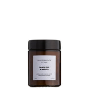 The Apothecary Black Fig & Neroli Candle in a minimalist glass jar, made with natural vegetable wax and a pure cotton wick, featuring a fresh fig, coconut, and floral fragrance.