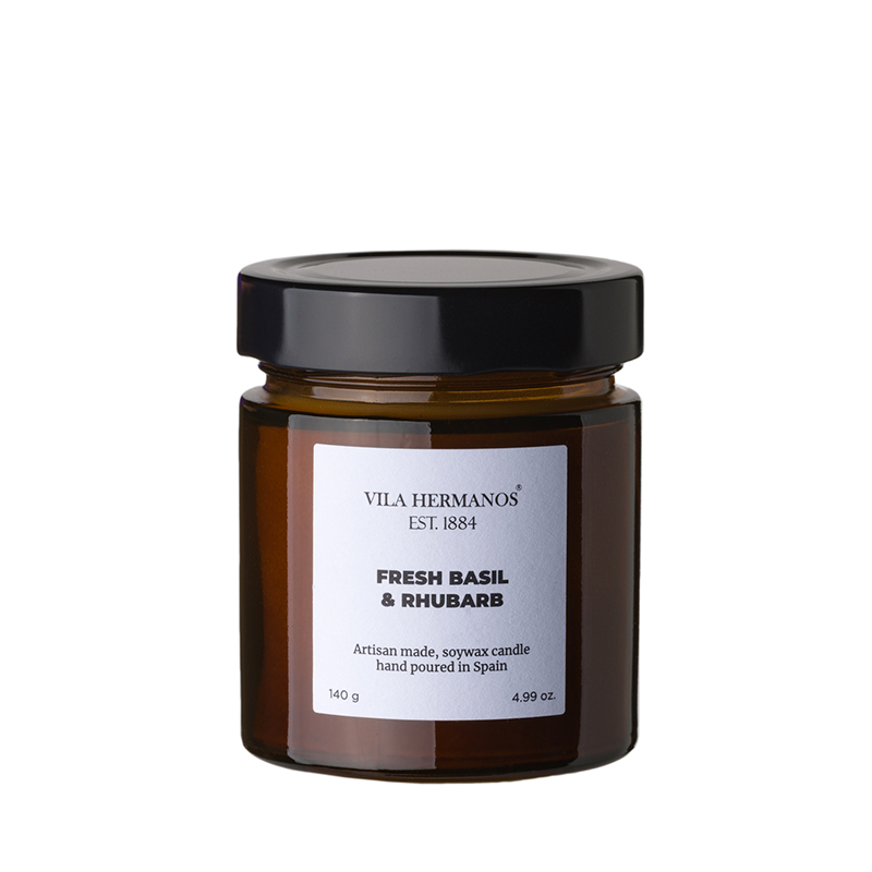 The Apothecary Fresh Basil & Rhubarb Candle in a simple glass jar, made with natural vegetable wax and a pure cotton wick, featuring a fresh, aromatic basil and rhubarb fragrance