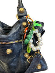 Handmade in Spain bag charms with colorful carabiners, peekaboo peas, friendly monsters, girly bows, and fun tags.