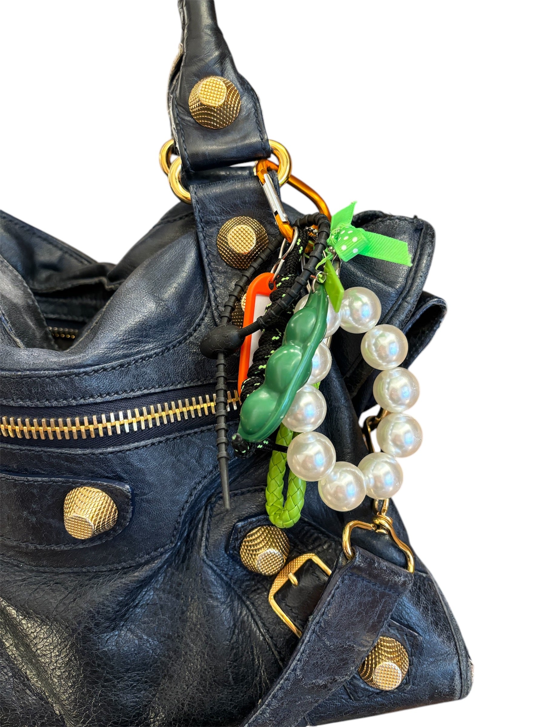 Handmade in Spain bag charms with colorful carabiners, peekaboo peas, friendly monsters, girly bows, and fun tags.