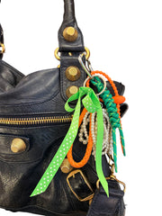 Handmade in Spain bag charms with colorful carabiners, peekaboo peas, friendly monsters, girly bows, and fun tags.