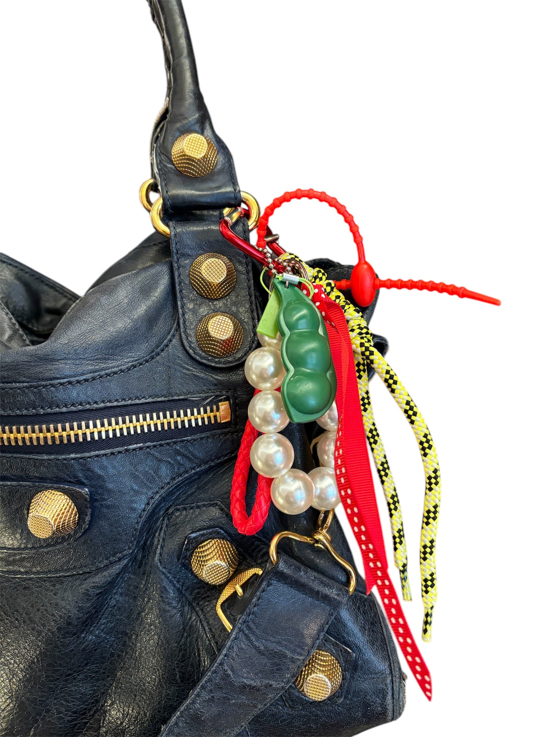 Handmade in Spain bag charms with colorful carabiners, peekaboo peas, friendly monsters, girly bows, and fun tags.